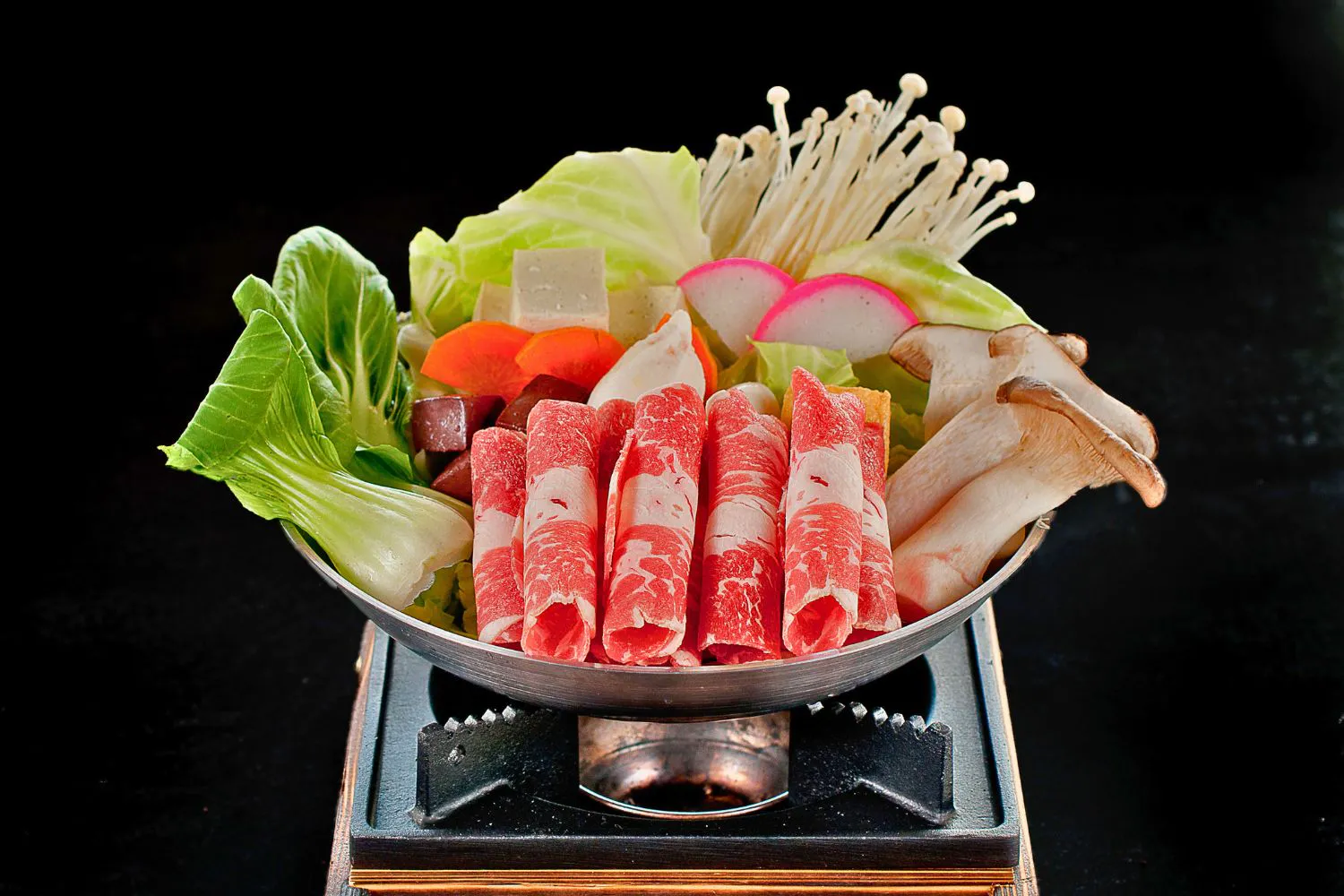 Raw beef roll hot pot platter filled with mushrooms, tofu and mixed greens at Feast Utopia Clackamas, an Asian Fusion Restaurant in Clackamas