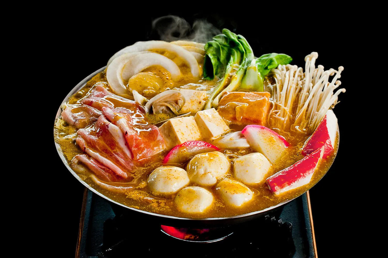 Simmering golden curry hot pot with beef, tofu, seafood and fresh vegetables at Feast Utopia Clackamas, an Asian Fusion Restaurant in Clackamas